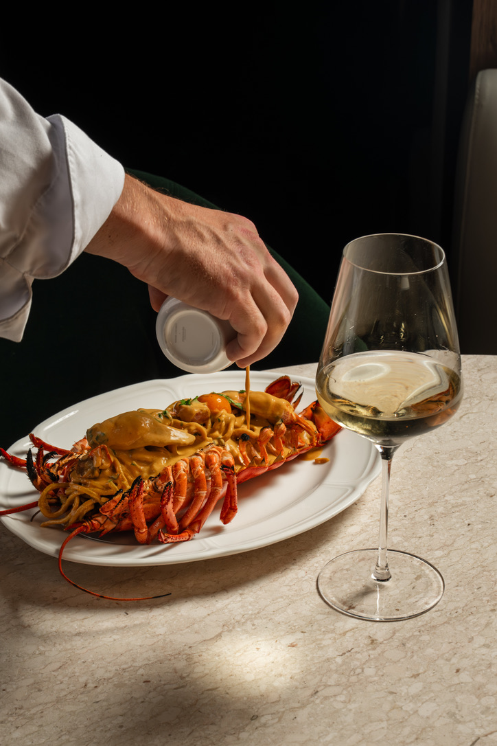 Lobster pasta being finished tableside